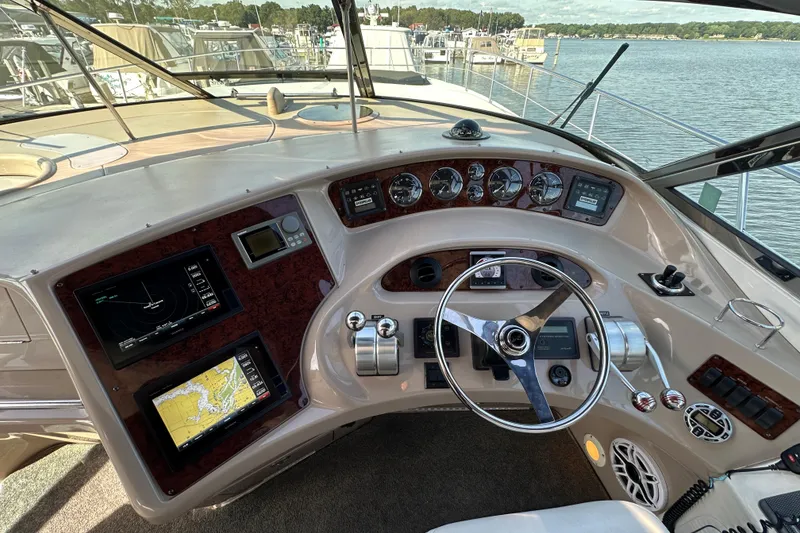 Slide: The Image of Cockpit of 2001 Sea Ray 510 Sundancer with navigation displays and steering wheel. - 11
