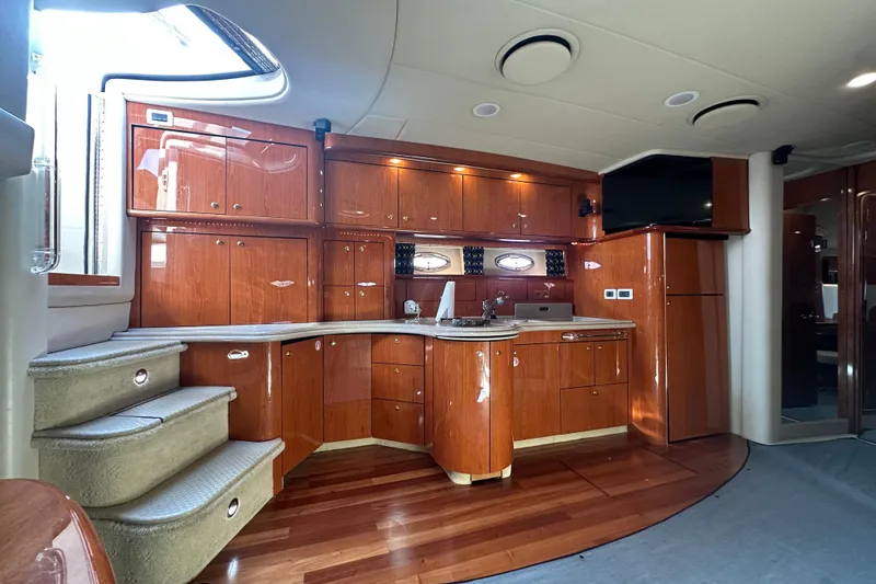 Slide: The Image of Luxurious interior of 2001 Sea Ray 510 Sundancer yacht with polished wood cabinetry and modern amenities. - 14