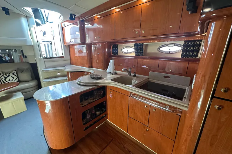 Slide: The Image of Luxurious 2001 Sea Ray 510 Sundancer yacht interior with elegant wood cabinetry and modern amenities. - 16