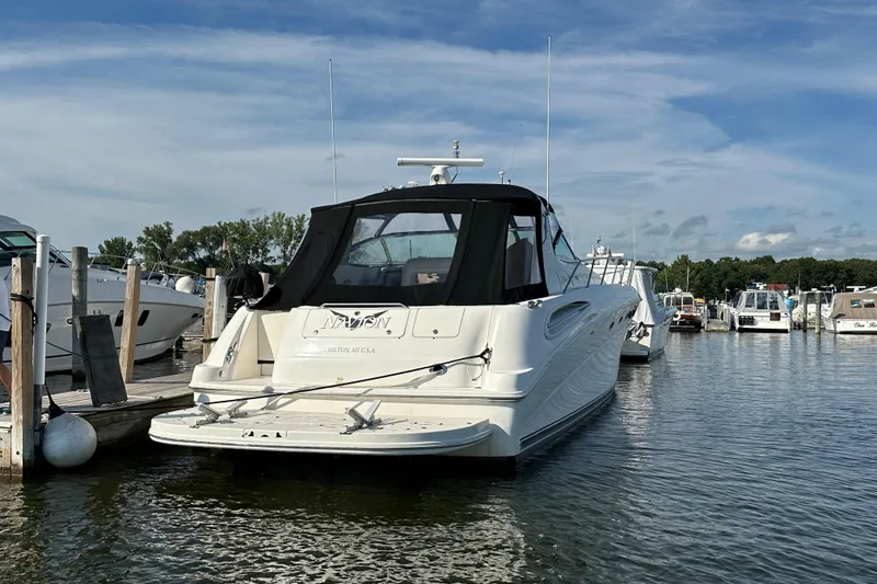 Slide: The Image of 2001 Sea Ray 510 Sundancer yacht docked at marina under blue sky. - 2