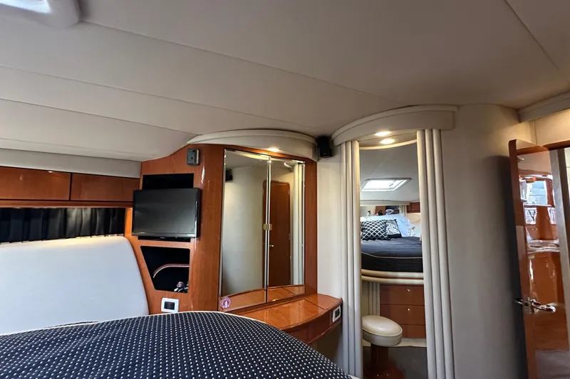 Slide: The Image of Interior of 2001 Sea Ray 510 Sundancer yacht with elegant wood finishes and cozy bedroom. - 22