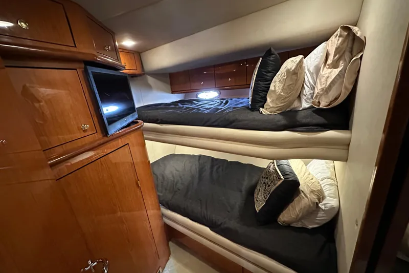 Slide: The Image of Luxurious cabin interior of 2001 Sea Ray 510 Sundancer with bunk beds and TV. - 25