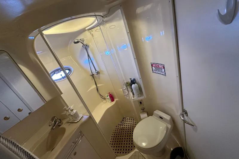 Slide: The Image of Bathroom interior of 2001 Sea Ray 510 Sundancer yacht, featuring shower and toilet. - 27