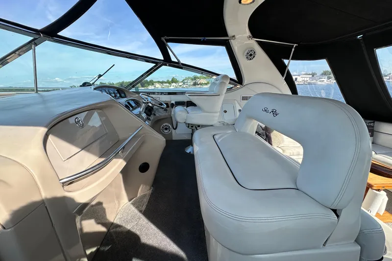 Slide: The Image of Interior of 2001 Sea Ray 510 Sundancer yacht with luxurious seating and helm. - 9