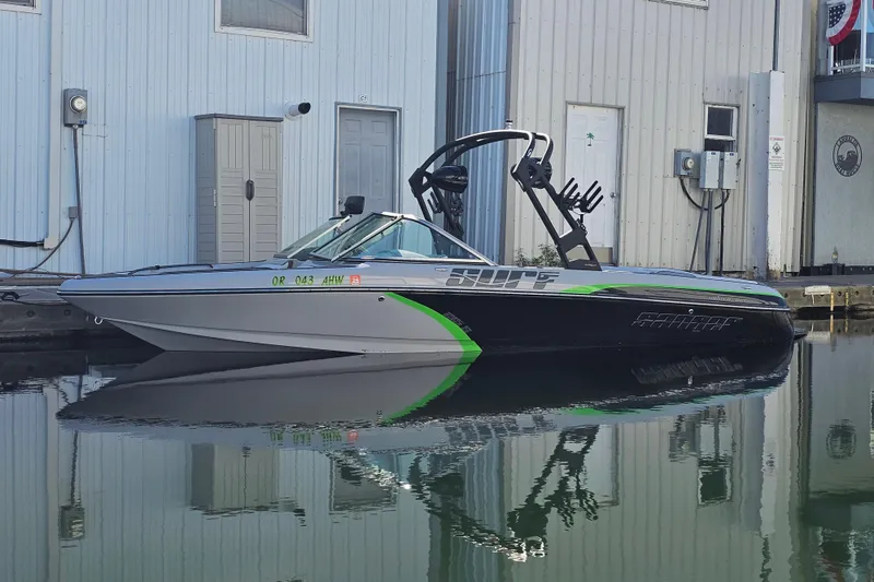The Image of 2023 Sanger V215 boat docked, featuring sleek design and vibrant green accents. - 1