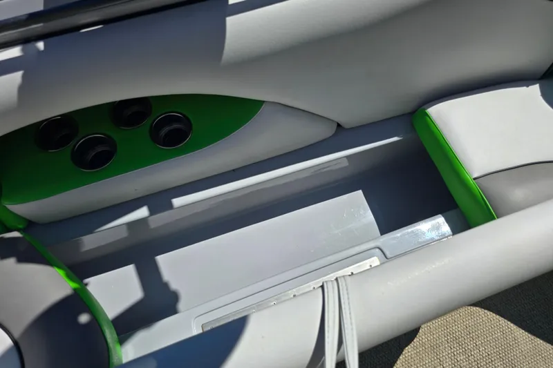 Slide: The Image of 2023 Sanger V215 boat interior with gray and green seating, cup holders. - 15