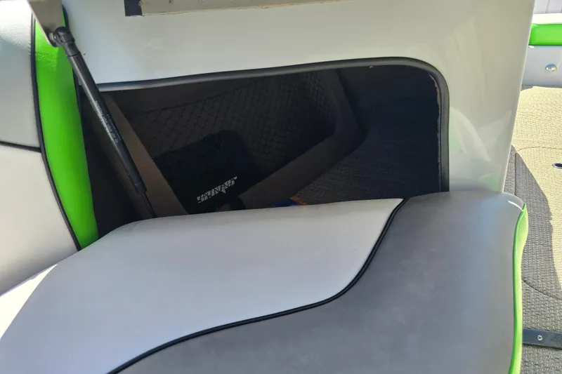 Slide: The Image of 2023 Sanger V215 boat interior storage compartment with green and gray upholstery. - 16