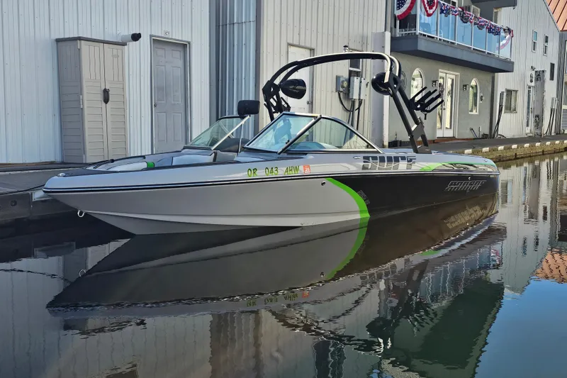 Slide: The Image of 2023 Sanger V215 boat docked on calm water, featuring sleek design and modern graphics. - 18