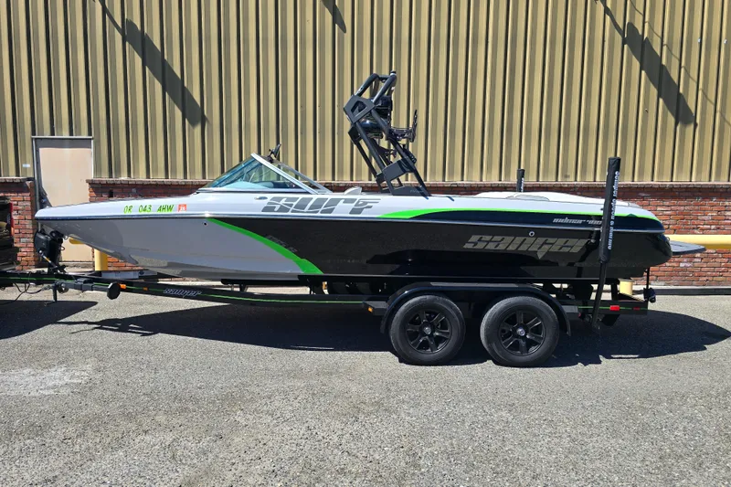 Slide: The Image of 2023 Sanger V215 boat on trailer, parked outdoors against a brick wall. - 27