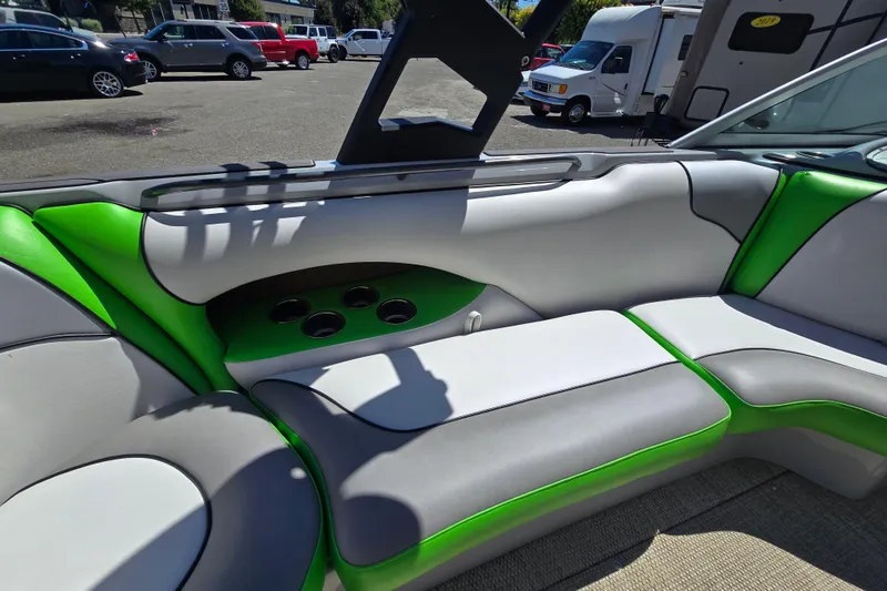 Slide: The Image of 2023 Sanger V215 boat interior with gray and green seating, cup holders, and modern design. - 31