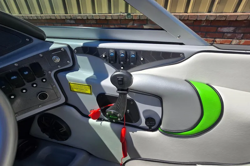 Slide: The Image of Interior of 2023 Sanger V215 boat with control panel and vibrant green accents. - 5