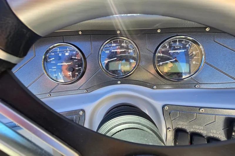 Slide: The Image of Dashboard of 2023 Sanger V215 boat with gauges and steering wheel. - 6