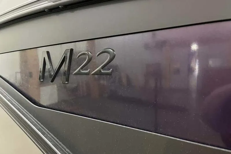 Slide: The Image of 2025 Bennington 22M Fastback SE boat, close-up of "M22" emblem. - 3