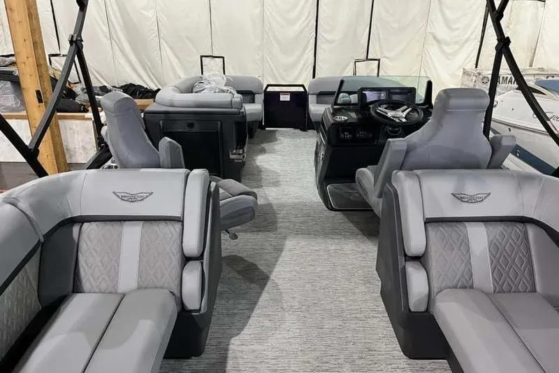 Slide: The Image of Interior of 2025 Bennington 22M Fastback SE pontoon boat with luxurious seating and modern dashboard. - 5