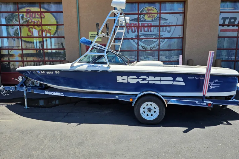 The Image of 2001 Moomba Outback boat on trailer, parked outside Bass Pro Shops. - 0