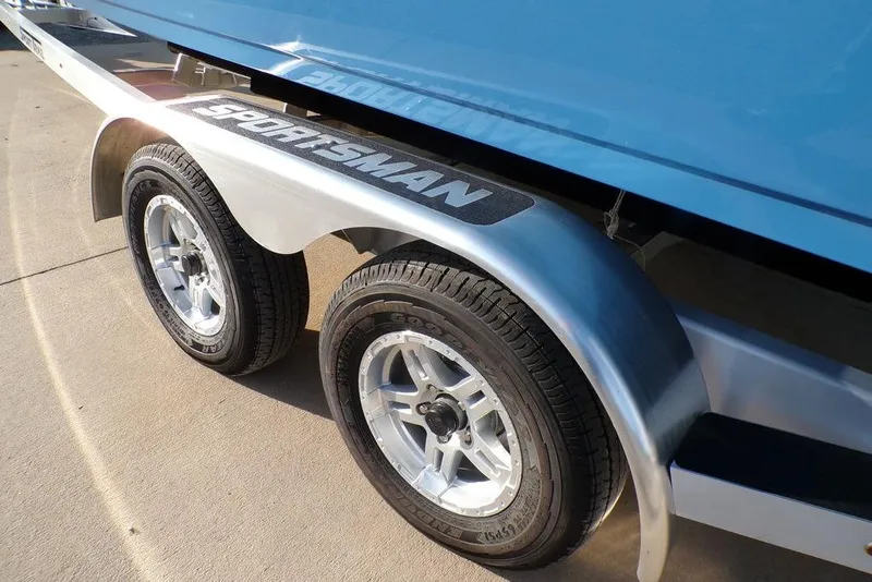Slide: The Image of Trailer of 2025 Sportsman Masters 247 boat with dual wheels and metallic fenders. - 10