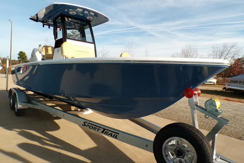 Slide: The Image of 2025 Sportsman Masters 247 boat on trailer, blue hull, parked outdoors. - 14