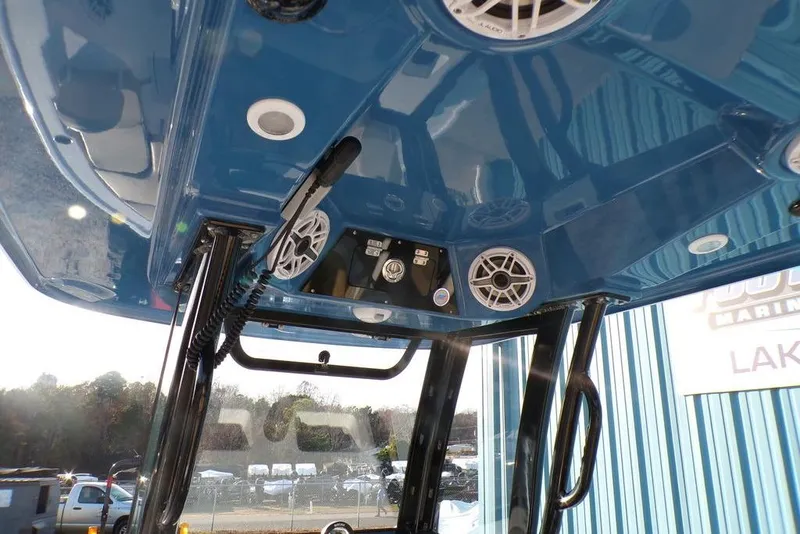Slide: The Image of 2025 Sportsman Masters 247 boat interior with blue ceiling, speakers, and control panel. - 16