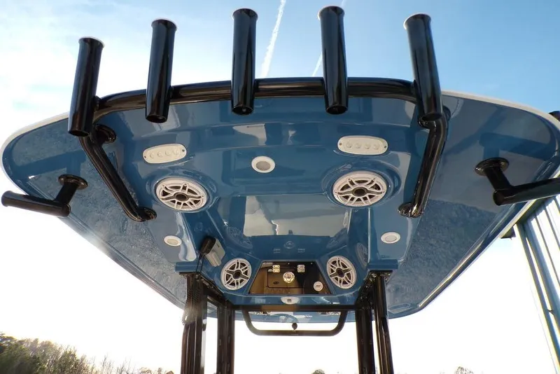 Slide: The Image of 2025 Sportsman Masters 247 boat T-top with rod holders and speakers, viewed from below. - 19