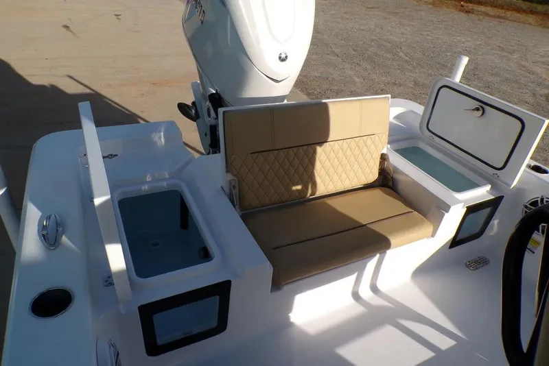 Slide: The Image of 2025 Sportsman Masters 247 boat interior with tan seating and storage compartments. - 20