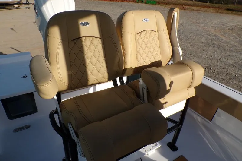 Slide: The Image of Beige leather seats on 2025 Sportsman Masters 247 boat, featuring diamond stitching and armrests. - 21