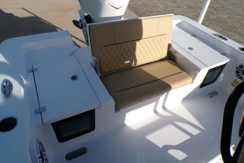 Slide: The Image of 2025 Sportsman Masters 247 boat interior with tan cushioned seating and storage compartments. - 22