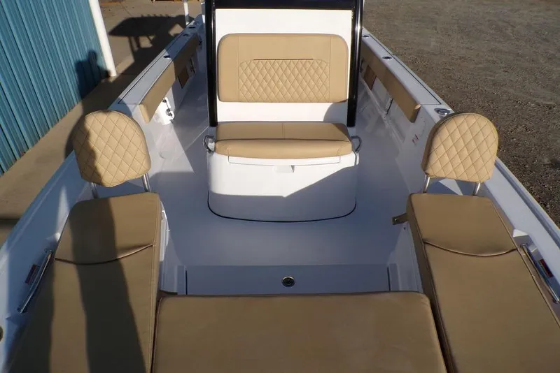 Slide: The Image of 2025 Sportsman Masters 247 boat interior with beige cushioned seating and white deck. - 24