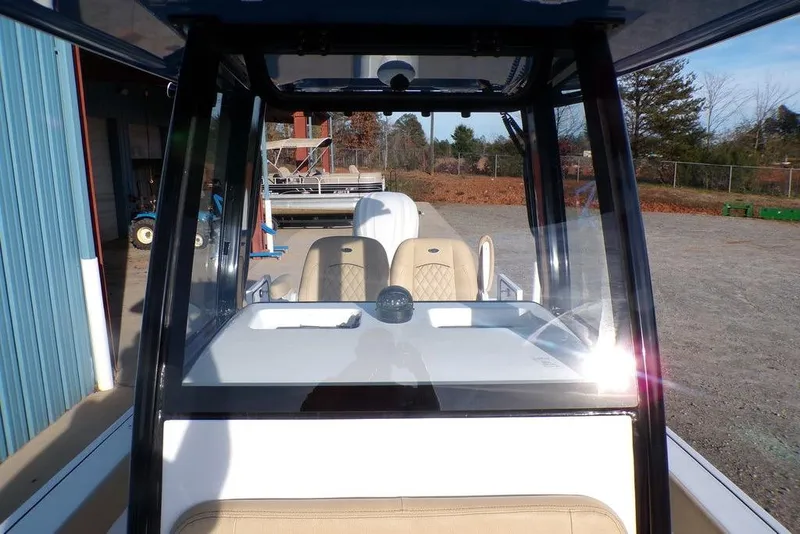 Slide: The Image of 2025 Sportsman Masters 247 boat interior with beige seating and clear windshield. - 29