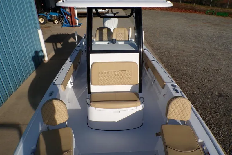 Slide: The Image of 2025 Sportsman Masters 247 boat interior with beige seating and console. - 31