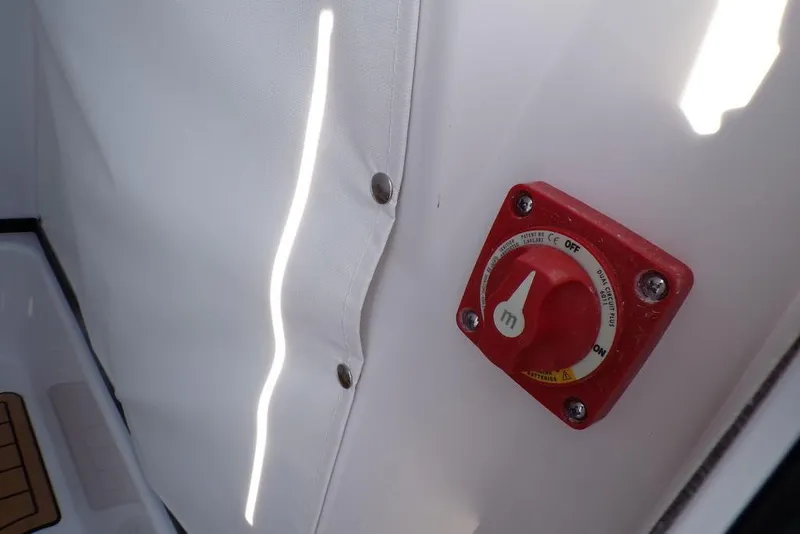 Slide: The Image of Red power switch on 2025 Sportsman Masters 247 boat interior. - 33