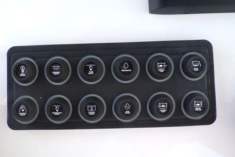 Slide: The Image of Control panel of a 2025 Sportsman Masters 247 boat with various function buttons. - 34