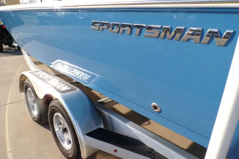 Slide: The Image of 2025 Sportsman Masters 247 boat on trailer, showcasing sleek blue design and branding. - 41