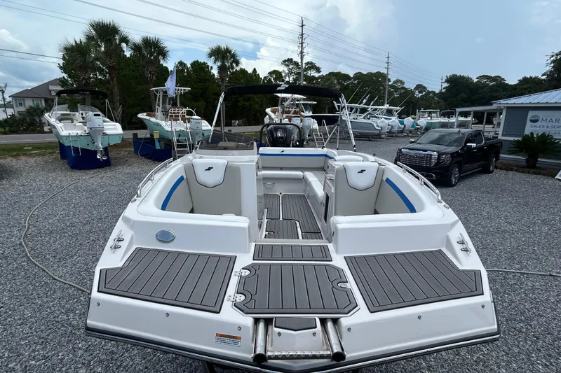 Slide: The Image of 2023 Starcraft SVX 231 OB DH boat displayed outdoors, surrounded by other boats and vehicles. - 10