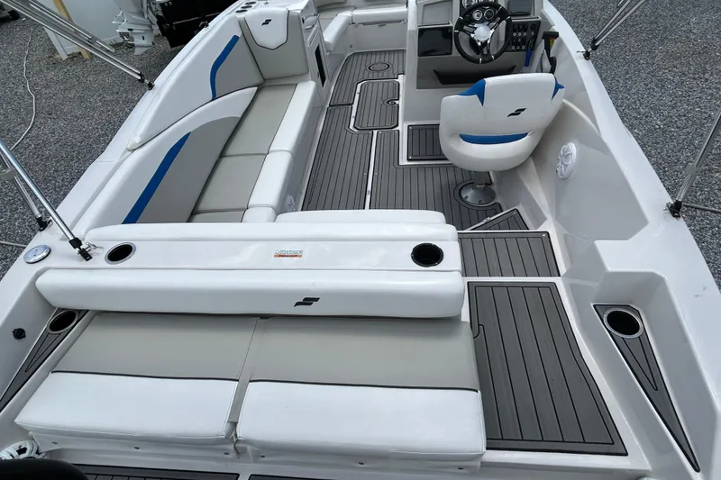 Slide: The Image of 2023 Starcraft SVX 231 OB DH boat interior with seating and steering console. - 14