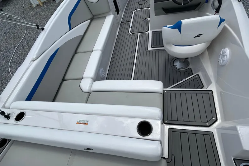 Slide: The Image of 2023 Starcraft SVX 231 OB DH boat interior with gray and blue seating, modern design. - 15