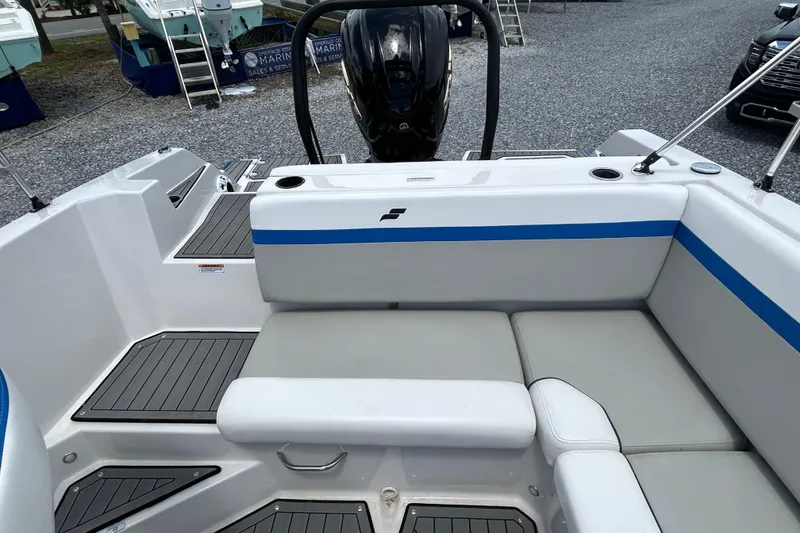 Slide: The Image of 2023 Starcraft SVX 231 OB DH boat interior with seating and motor view. - 16