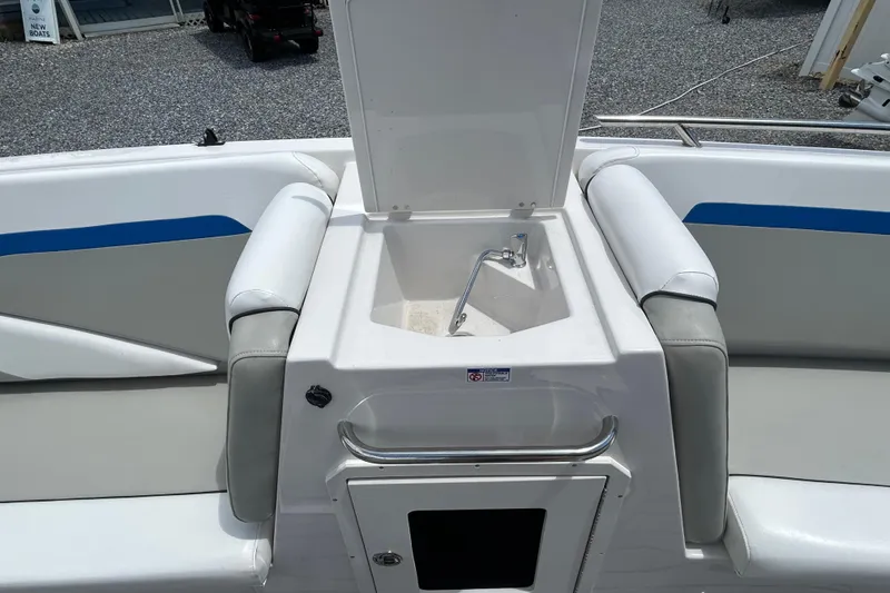 Slide: The Image of 2023 Starcraft SVX 231 OB DH boat interior with open storage compartment and seating. - 19
