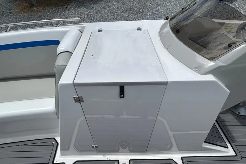 Slide: The Image of 2023 Starcraft SVX 231 OB DH boat interior with storage compartment and seating. - 20
