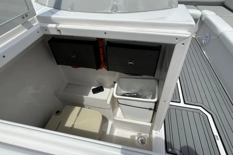 Slide: The Image of 2023 Starcraft SVX 231 OB DH boat interior with storage compartments and seating area. - 22