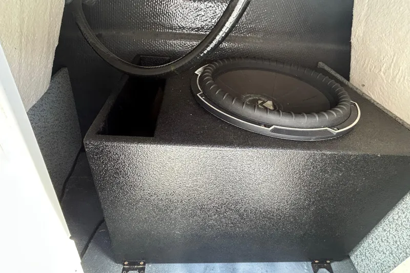 Slide: The Image of 2023 Starcraft SVX 231 OB DH boat interior with subwoofer and black enclosure. - 23