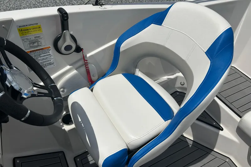 Slide: The Image of Captain's seat in 2023 Starcraft SVX 231 OB DH boat, featuring blue and white upholstery. - 26