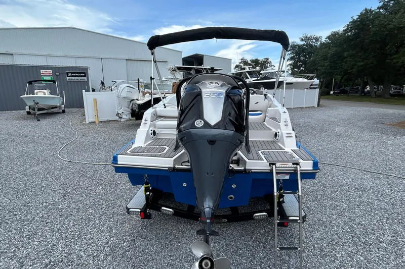 Slide: The Image of 2023 Starcraft SVX 231 OB DH boat with outboard motor, parked on gravel lot. - 6