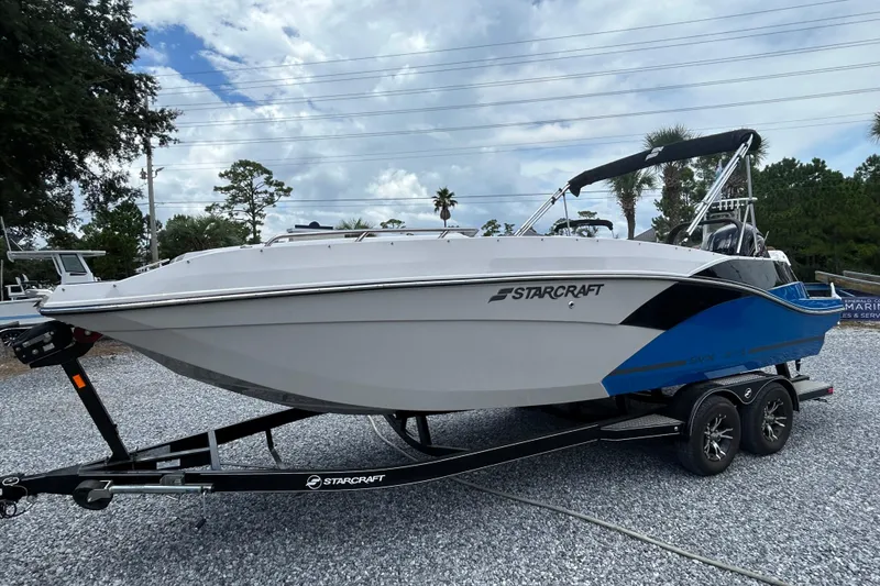 Slide: The Image of 2023 Starcraft SVX 231 OB DH boat on trailer, parked outdoors. - 9