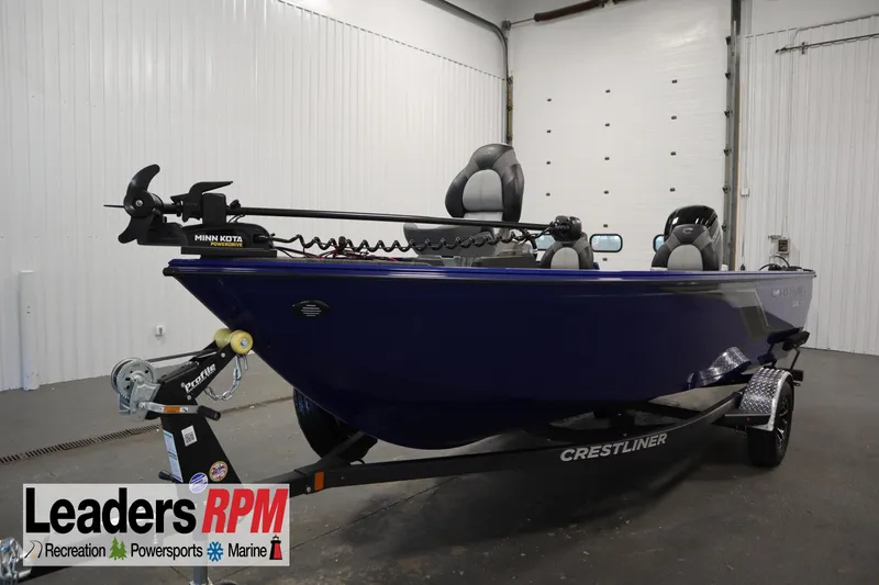 The Image of 2026 Crestliner 1650 Hawk Side Console boat in showroom, featuring Minn Kota trolling motor. - 0