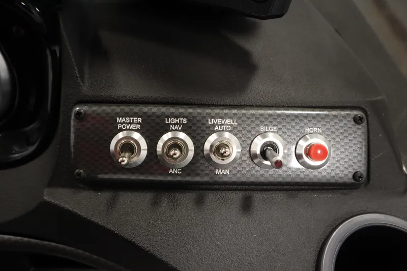 Slide: The Image of Control panel of 2026 Crestliner 1650 Hawk Side Console with switches for power, lights, and horn. - 27
