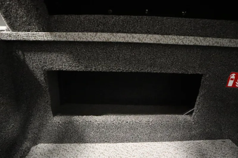 Slide: The Image of 2026 Crestliner 1650 Hawk Side Console interior storage compartment with carpeted finish. - 29