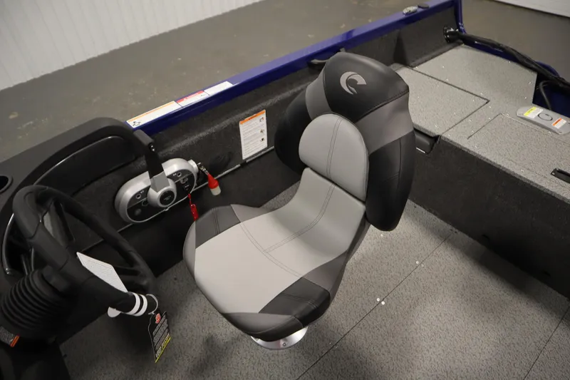 Slide: The Image of 2026 Crestliner 1650 Hawk Side Console interior with steering wheel and cushioned seat. - 32