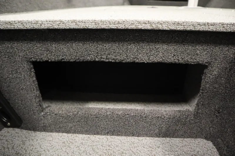 Slide: The Image of Carpeted storage compartment in 2026 Crestliner 1650 Hawk Side Console boat. - 33