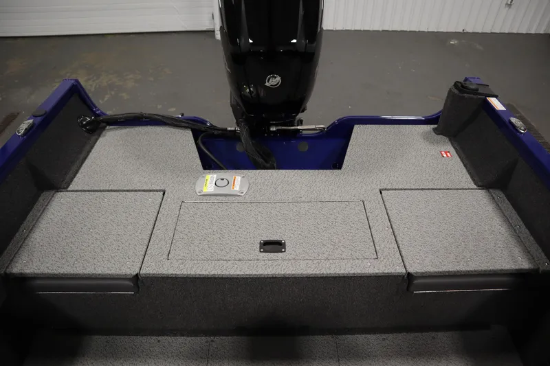 Slide: The Image of 2026 Crestliner 1650 Hawk Side Console boat interior with storage compartments and motor. - 37