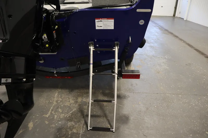 Slide: The Image of 2026 Crestliner 1650 Hawk Side Console boat with rear ladder and motor detail. - 42